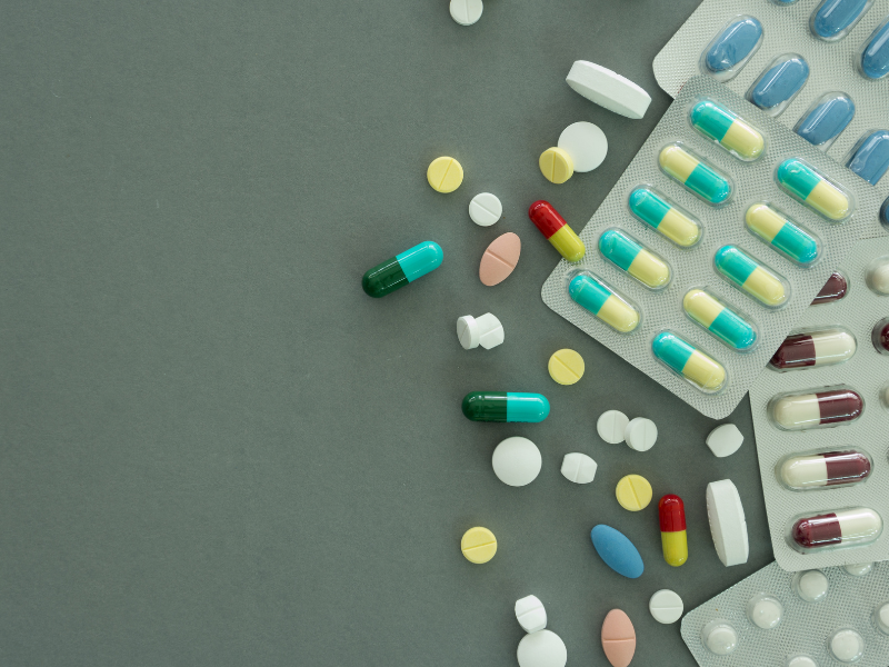 Various medications and pills laid across a flat surface